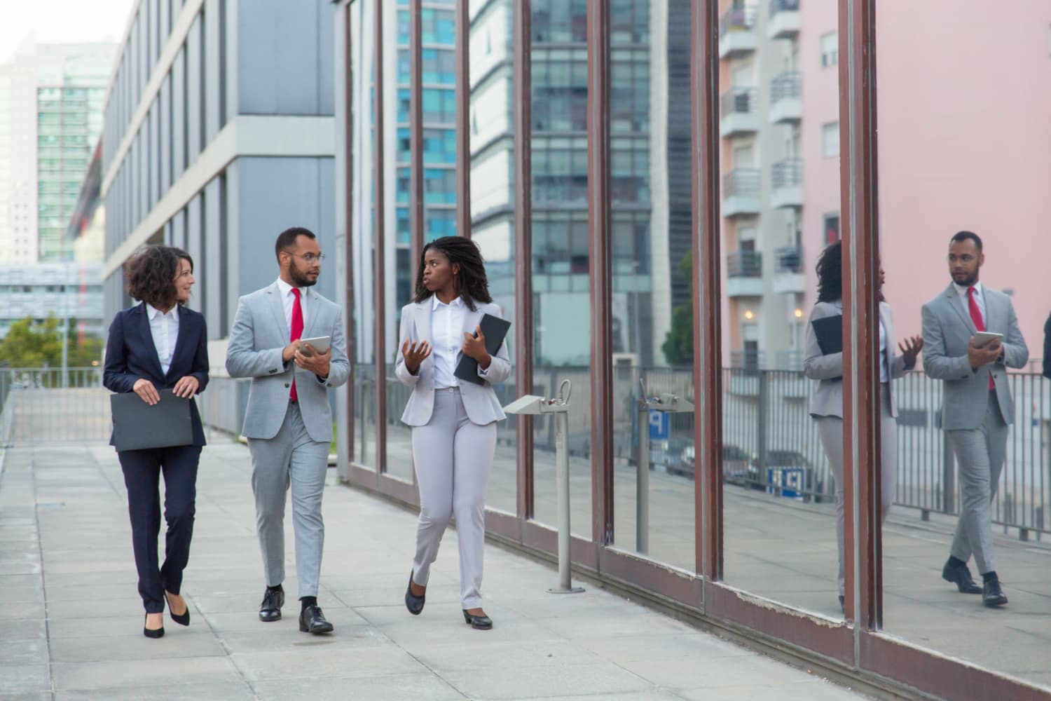 Diverse executive team walking outside a Lagos office building